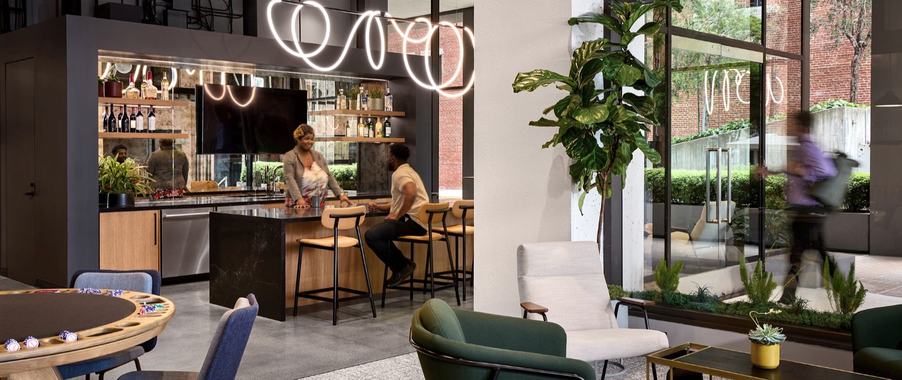 Sleek and modern tenant amenity lounge with kitchen, bar and games