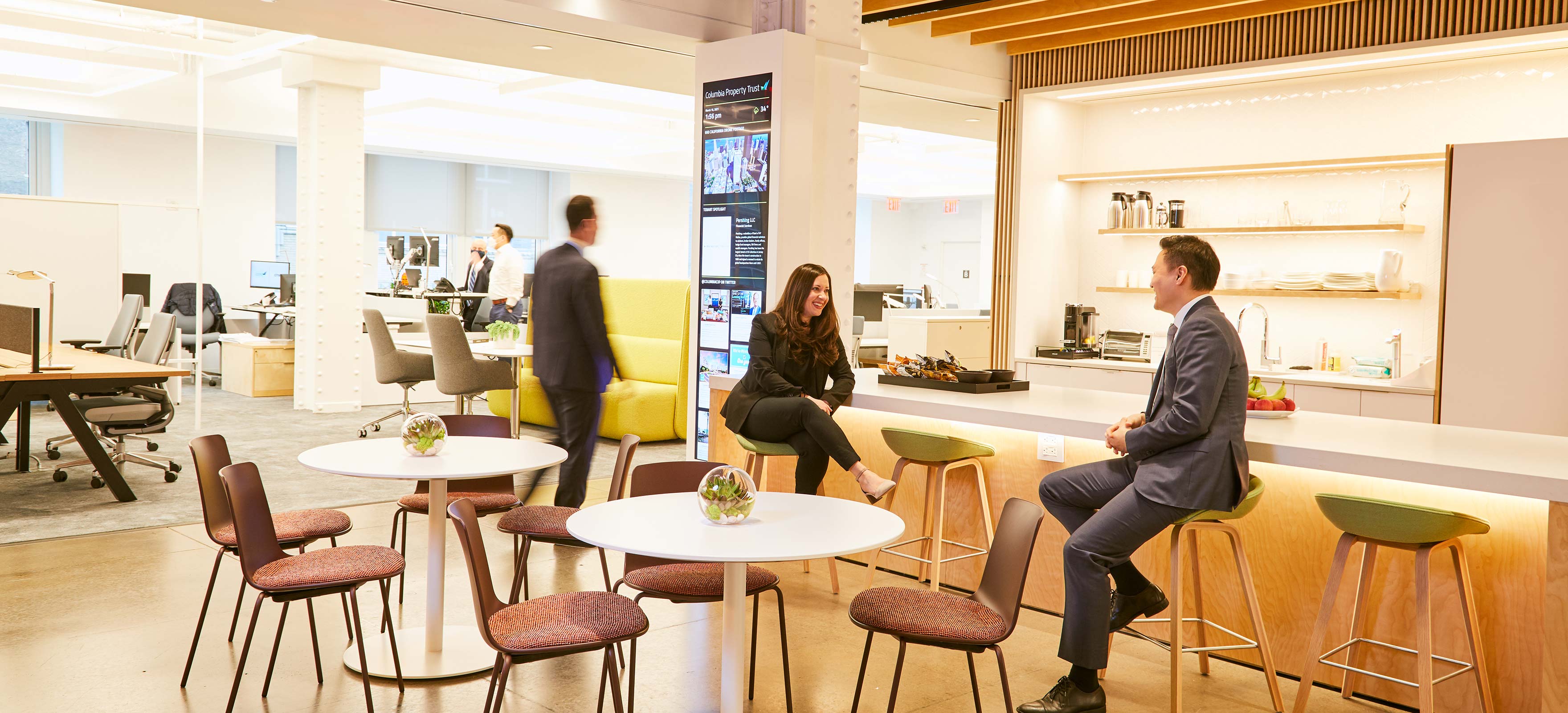 Coworkers chatting in modern office in NYC